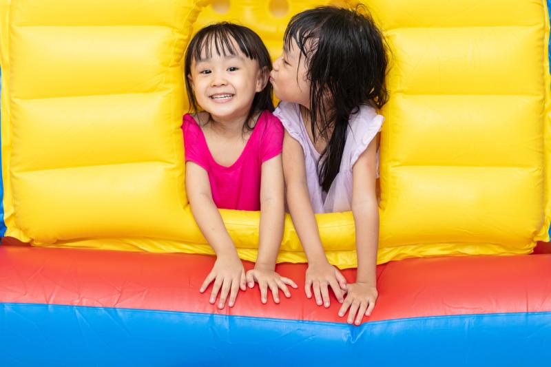 Two girls smile at the camera while in a bouncy house at catapult adventure park lakewood