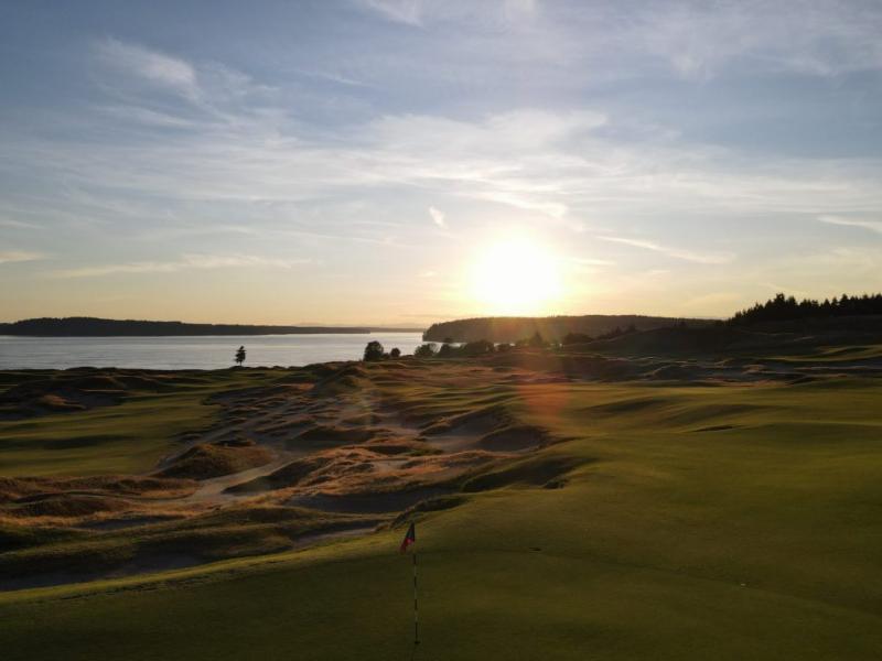 The golf course at sunset looking over the holes and the Puget Sound