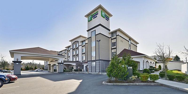 The hotel from the outside looking at the parking lot and building