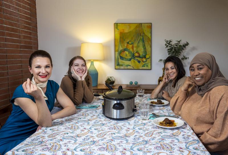 Four women sitting at a dining room table